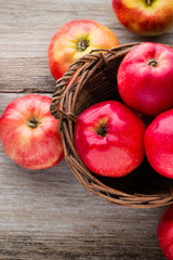 Ripe red apples on wooden background.