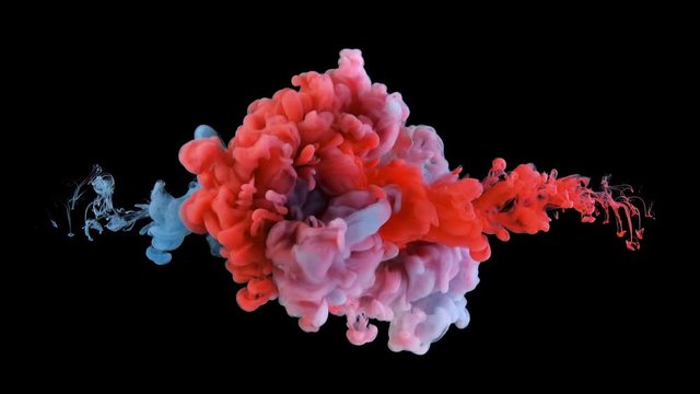 Real shot color paint drops in water in slow motion. Ink swirling underwater. Cloud of ink collision isolated on black background with alpha. Colorful abstract smoke explosion animation. Close up view