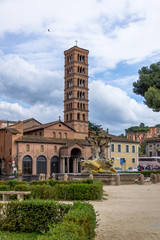 Obraz premium Tritons fountain and Basilica of Saint Mary in Cosmedin (Santa Maria in Cosmedin) at Piazza Bocca della Verita (Mouth of the Truth) - Rome, Italy