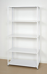 white metal rack near the wall, empty shelves