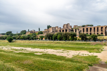 Fototapeta na wymiar View of Palatine Hill and Imperial Palace from Circus Maximus field (an ancient chariot racing stadium) - Rome, Italy