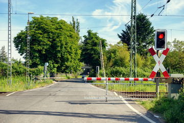Automated rural level crossing with the barriers down and flashing red light