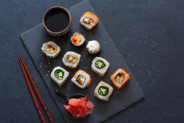 Set of  sushi rolls served on stone slate