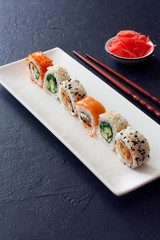 Set of  sushi rolls served on white plate