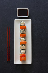 Set of  sushi rolls served on white plate