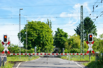 Automated rural level crossing with the barriers down and flashing red light