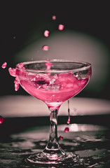 pink drink splashing in glass