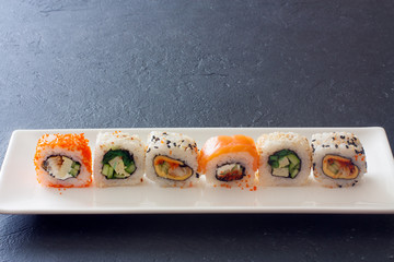 Set of  sushi rolls served on white plate