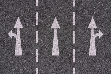 white arrows and lines on asphalt texture - freeway exit