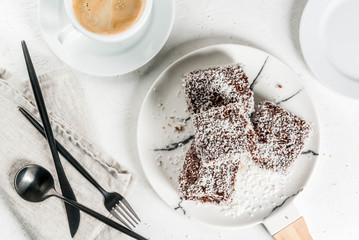 Australian food. Traditional dessert Lamington - pieces of biscuit in dark chocolate, sprinkled...