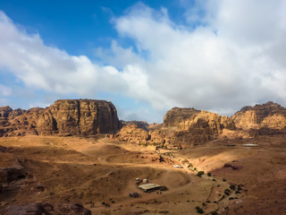 PETRA, JORDAN, NOV 25, 2011: Panoramic view of a red rose rock formation against a blue sky in Petra (Rose City)