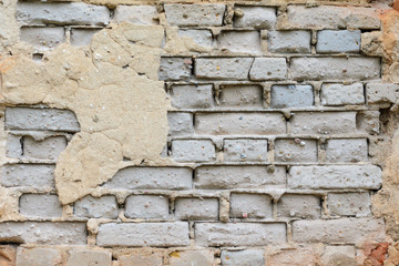 Red brick wall texture shattered by time. Grunge background