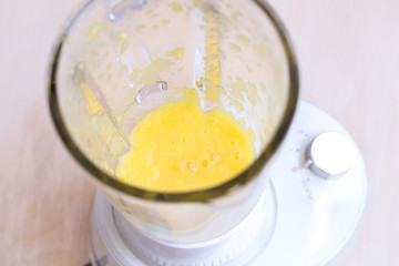 Preparing an orange cocktail in a blender. Shaking. The concept of a healthy diet