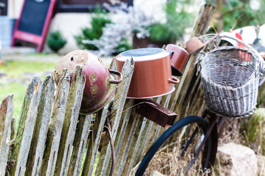 Old wooden fence with pots on it