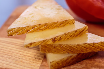 Slices of cheese. Typical Spanish tapa of Manchego curado cheese