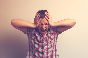 Portrait of stressed woman holding head in hands