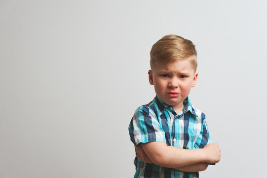 Portrait of angry crying child looking at camera