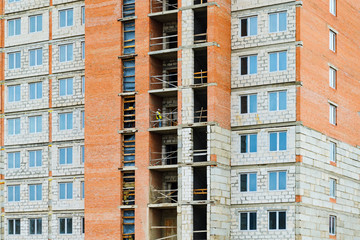 Fototapeta premium Facade of a multi-storey residential building under construction