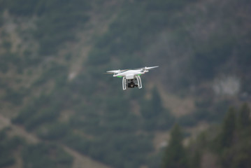 Fototapeta na wymiar Drone quadcopter flying over mountain countryside area