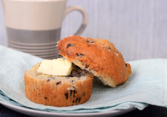 Blueberry muffin with butter and coffee