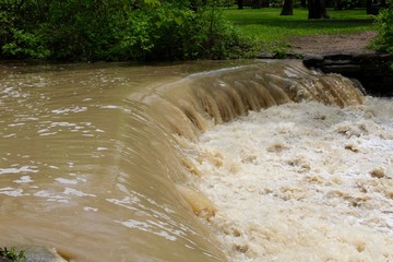 The fast moving water of the waterfall.