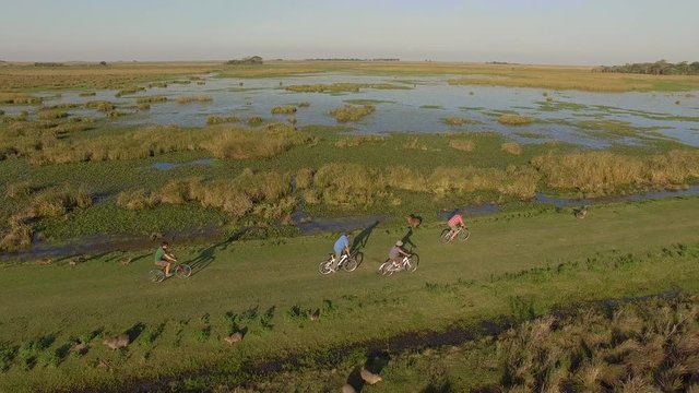 Tourists bicycling in Ibera Wetlands, Corrientes Province, Argentina