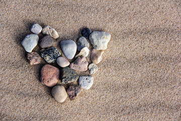 Fototapeta na wymiar I Love You on Sand Background, Stone Heart. Valentine's Day Concept
