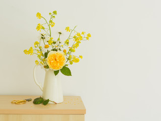 Yellow wild flower bouquet in white jug