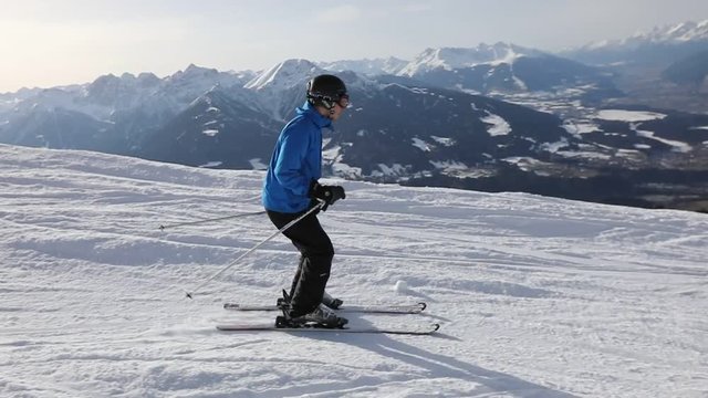 skier in slow motion in austrian Alps, skiing in beautiful mountain landscape