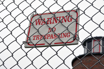 Fototapeta na wymiar Warning Caution No Trespassing Sign
