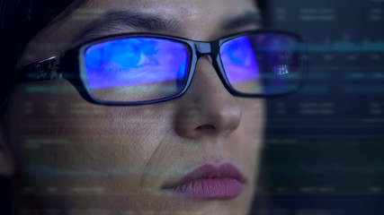 The serious businesswoman with a glasses look to the virtual screen