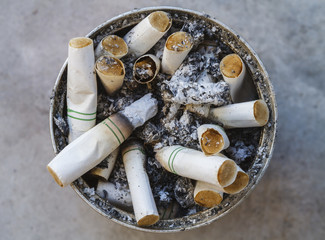 Cigarette butts discarded in ashtray.