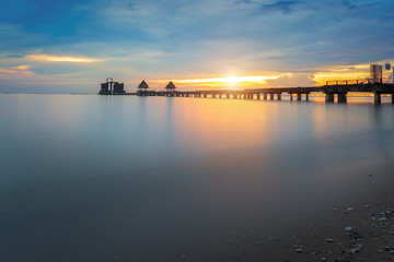 Fototapeta na wymiar Landscape of Wooded bridge in the port between sunrise
