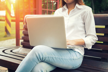 Young woman working with laptop at the park