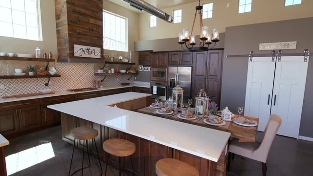 Lowering on Modern Kitchen Island with Stools. a loft style rustic industrial kitchen lowers to reveal kitchen island with stools
