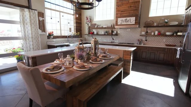 Rising Modern Kitchen with Dining Table. rising shot of a modern rustic industrial kitchen and lighting
