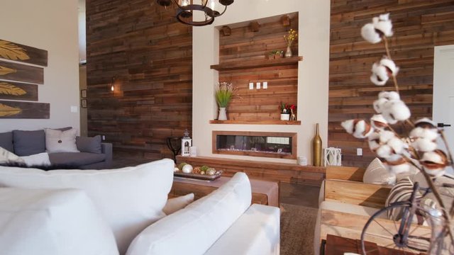 Living Room Reveal Wood Wall from Behind Plant. a large modern rustic industrial living room with a large reclaimed wood wall revealed from behind a plant
