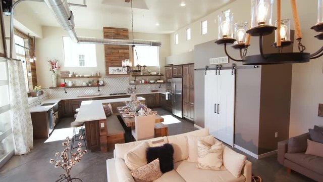 Modern Open Living Space with Kitchen Lower Left Angle. a lowering shot of a unique modern rustic industrial living open floor plan living space with kitchen and high ceilings
