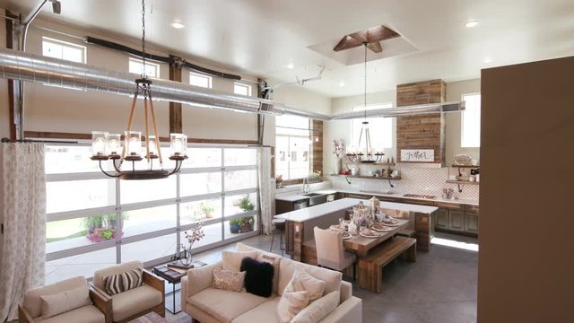 Modern Open Living Space with Kitchen Lower Right Angle. a lowering shot of a unique modern rustic industrial living open floor plan living space with kitchen and high ceilings
