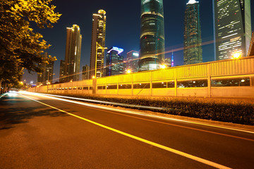 Obraz na płótnie Canvas Empty road surface with city landmark buildings of night