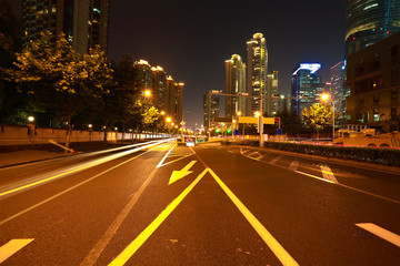 Fototapeta premium Empty road surface with city landmark buildings of night