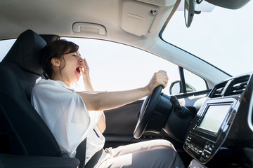 yawning female driver. falling asleep at the wheel concept. - obrazy, fototapety, plakaty