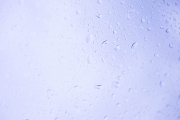 Water drops of rain on glass background