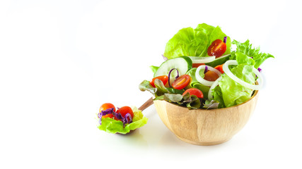vegetables salad in a wooden bowl isolated on white