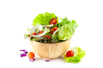 vegetables salad in a wooden bowl isolated on white