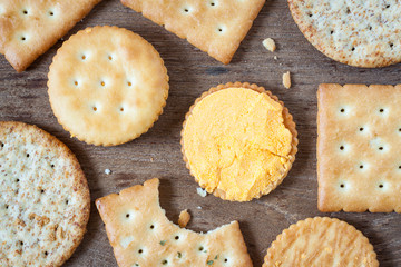 Crackers or biscuit on wooden background, top view