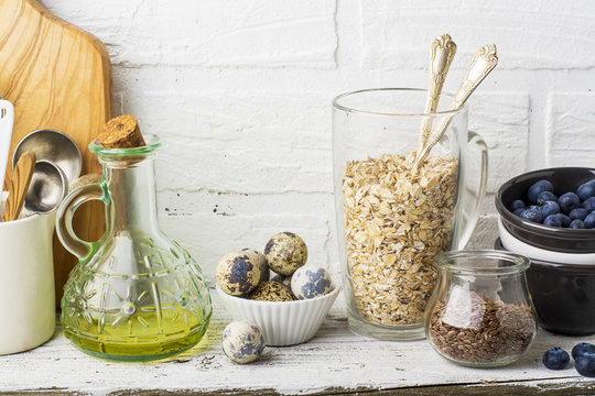 Kitchen tools, olive cutting board on a kitchen shelf against a white brick wall. selective focus