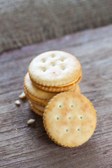 Crackers with cream on wooden background