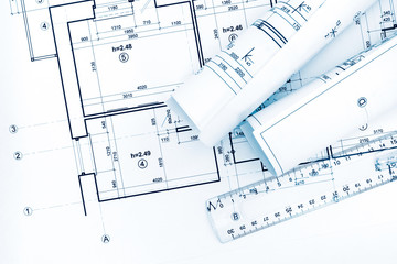 rolls of drawing paper with blueprints and architectural plans