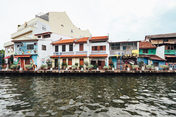 Fototapeta na wymiar Colorful chinese colonial buildings decorated with wall art painted near the river in Malacca City, Malacca, Malaysia.